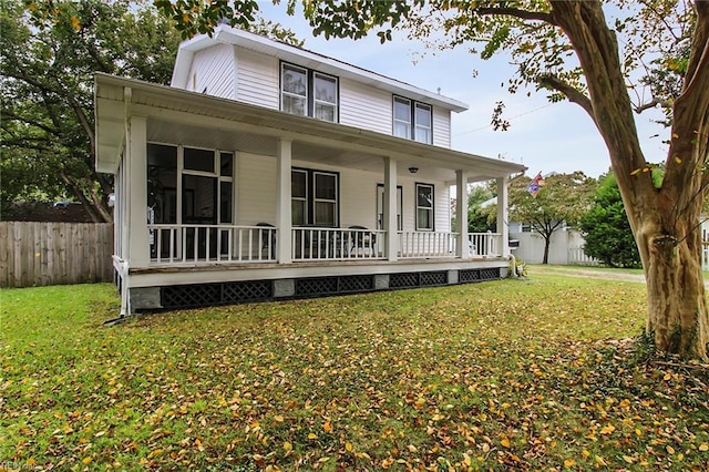 farmhouse-style home featuring a front yard and covered porch