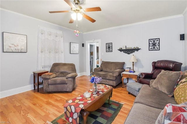 living room featuring wood-type flooring, ceiling fan, and crown molding