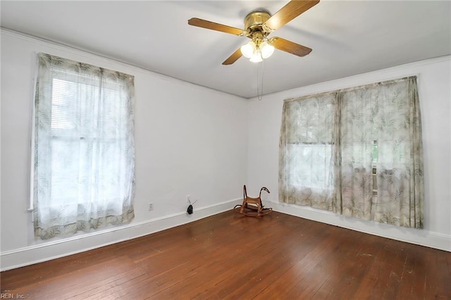 spare room with ceiling fan, hardwood / wood-style flooring, and crown molding