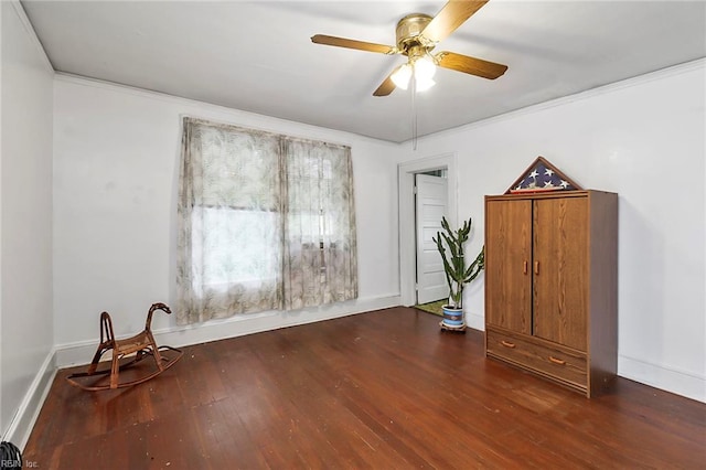 miscellaneous room with ornamental molding, dark wood-type flooring, and ceiling fan