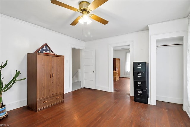 unfurnished bedroom with ceiling fan, dark hardwood / wood-style floors, and ornamental molding