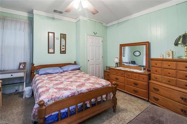 bedroom with a closet, ceiling fan, and carpet flooring