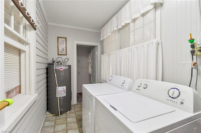 clothes washing area featuring electric water heater, separate washer and dryer, and ornamental molding