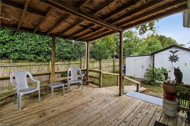 wooden terrace featuring a storage unit