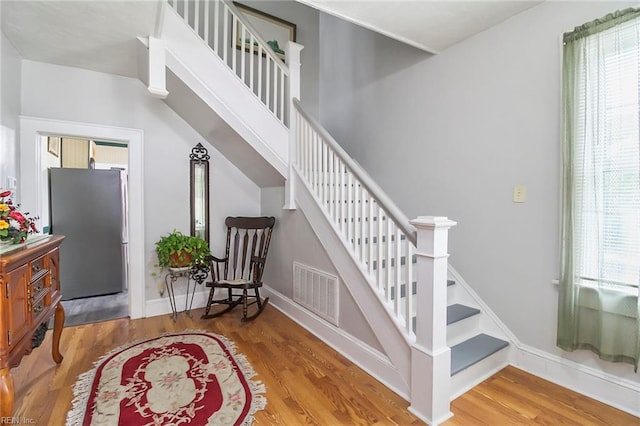 stairs featuring hardwood / wood-style floors