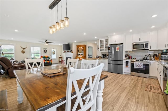 15338 Everets Rd, Windsor, VA 23487 - dining area with light wood-style flooring, ceiling fan, recessed lighting, and a fireplace