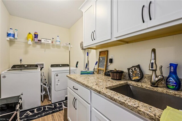 15338 Everets Rd, Windsor, VA 23487 - laundry room featuring independent washer and dryer, wood finished floors, and cabinet space