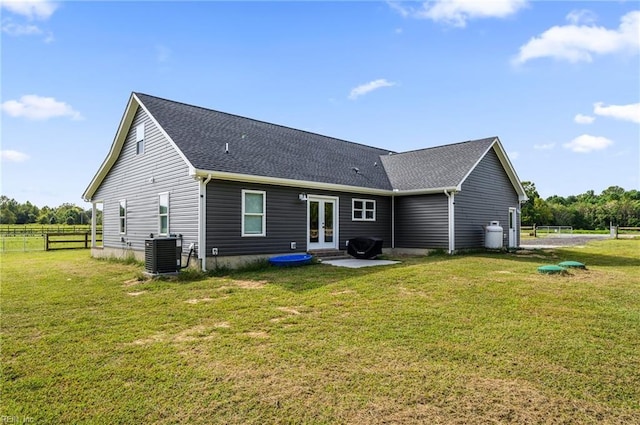 15338 Everets Rd, Windsor, VA 23487 - back of property featuring french doors, central AC unit, a patio area, and a shingled roof