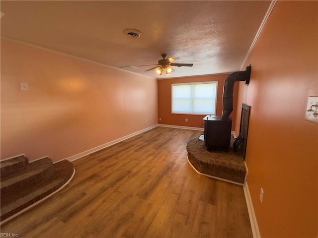 interior space featuring ceiling fan, hardwood / wood-style floors, and crown molding