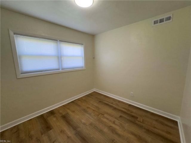 unfurnished room with dark hardwood / wood-style floors