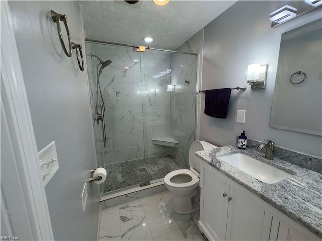 bathroom featuring vanity, a textured ceiling, toilet, and a shower with door