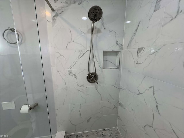 bathroom with tiled shower