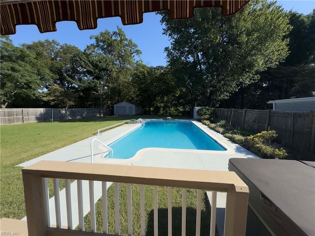 view of swimming pool featuring a storage unit, a patio, and a yard