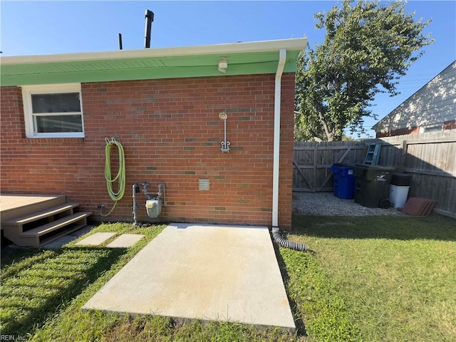 rear view of property with a lawn and a patio