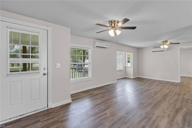 foyer with an AC wall unit, ceiling fan, and dark wood-type flooring