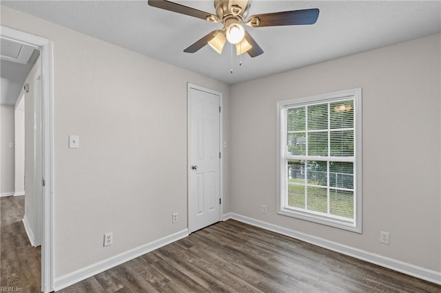 unfurnished room featuring ceiling fan and dark hardwood / wood-style floors