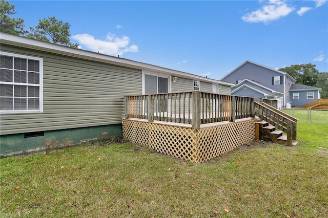 back of house with a wooden deck and a yard