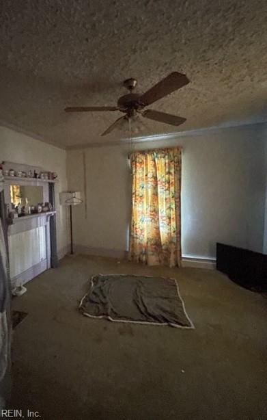 unfurnished living room featuring a textured ceiling, carpet floors, and ceiling fan