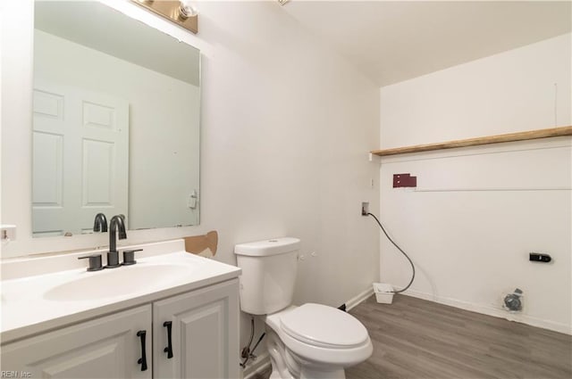 bathroom with vanity, hardwood / wood-style floors, and toilet