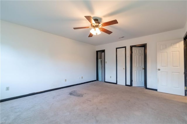 unfurnished bedroom with ceiling fan and light colored carpet