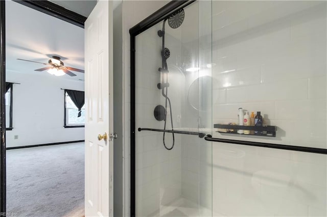 bathroom featuring ceiling fan and a shower with door