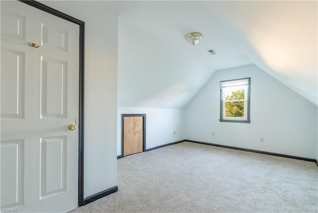 bonus room featuring lofted ceiling and light carpet