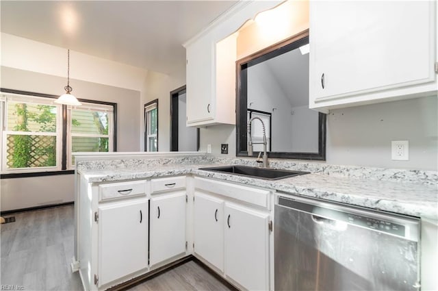 kitchen featuring white cabinets, kitchen peninsula, dishwasher, lofted ceiling, and decorative light fixtures