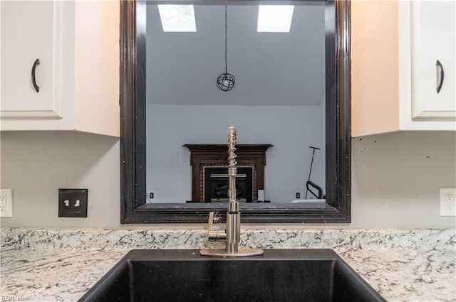 room details featuring white cabinets and a skylight