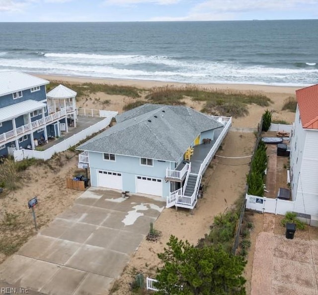 drone / aerial view featuring a water view and a beach view