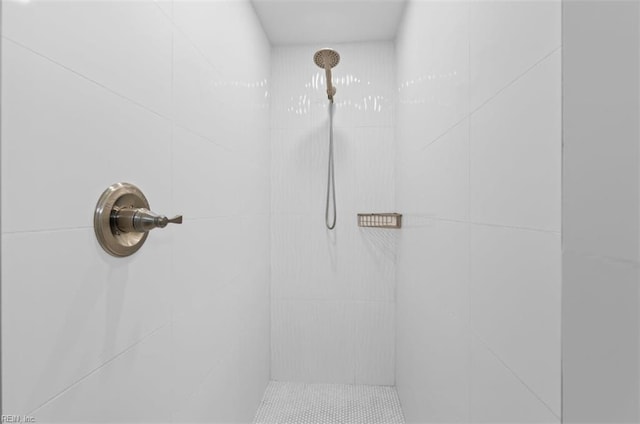 bathroom with tiled shower