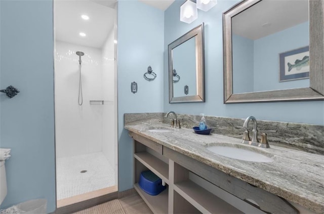 bathroom with walk in shower and vanity