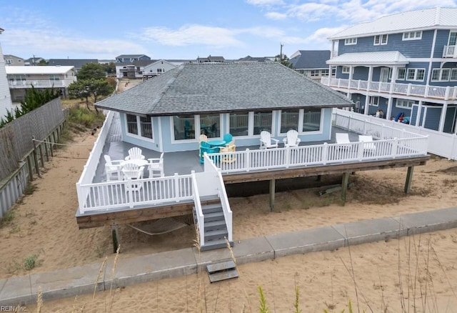 back of property featuring a deck