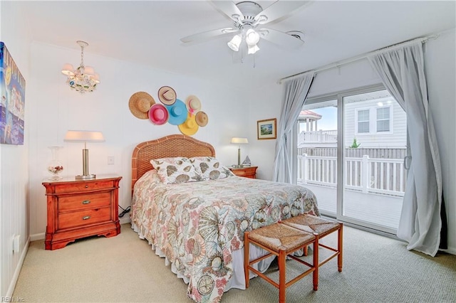 carpeted bedroom featuring ceiling fan with notable chandelier and access to exterior