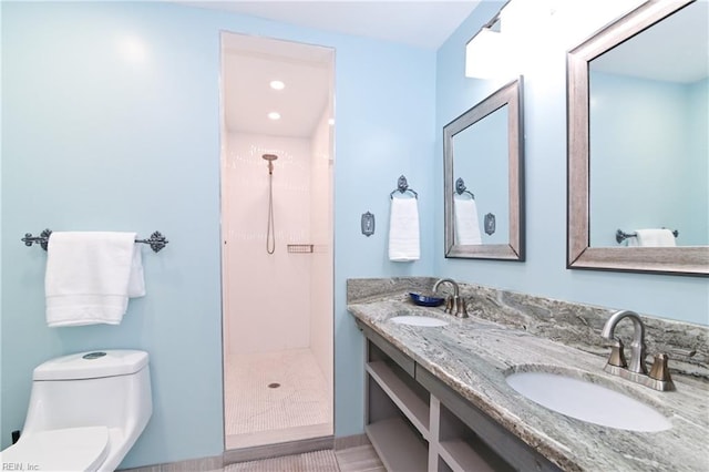 bathroom featuring toilet, walk in shower, and vanity