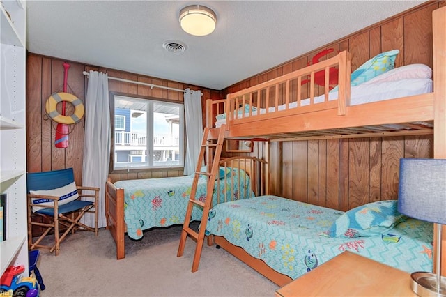 carpeted bedroom with wooden walls