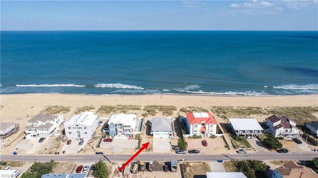 birds eye view of property featuring a water view and a view of the beach