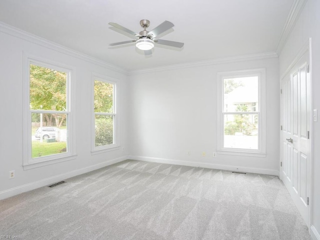 carpeted spare room featuring ornamental molding and ceiling fan