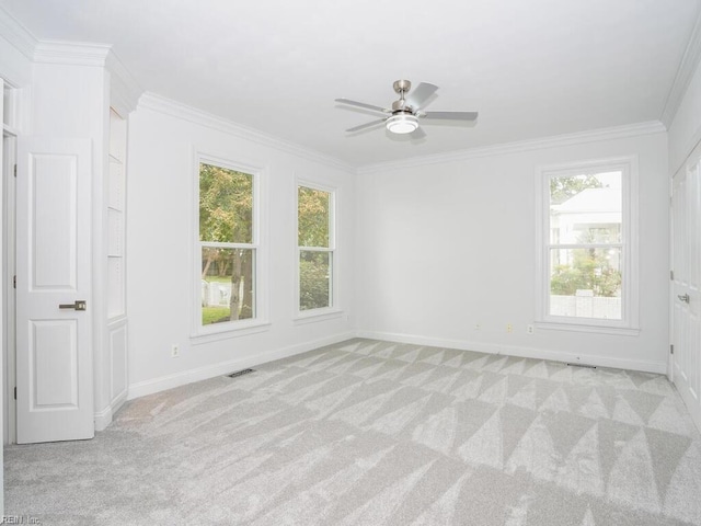 carpeted empty room with ornamental molding and ceiling fan