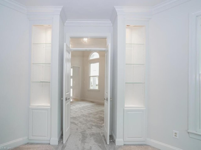 entrance foyer featuring ornamental molding and light colored carpet