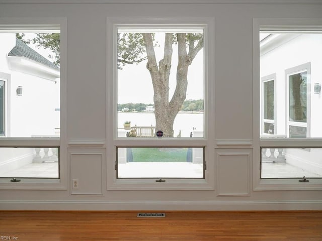 interior space with light hardwood / wood-style floors and a healthy amount of sunlight