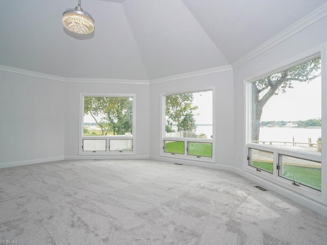 unfurnished room featuring lofted ceiling, a water view, carpet flooring, and crown molding