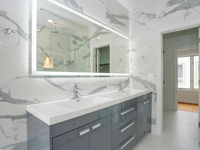 bathroom featuring a tile shower and vanity