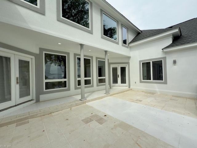 rear view of house featuring a patio and french doors