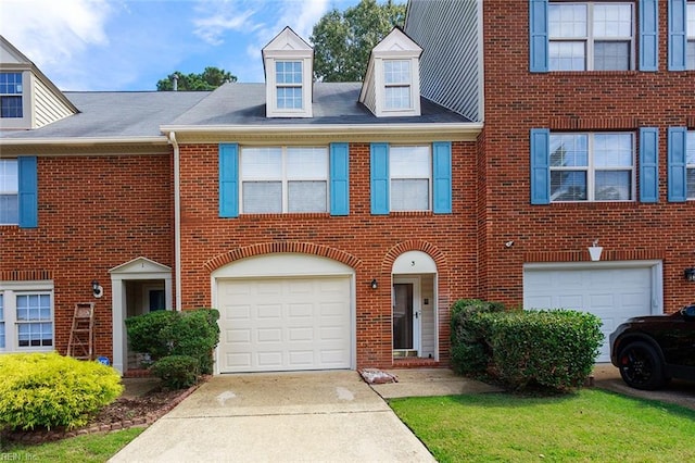 townhome / multi-family property featuring a garage