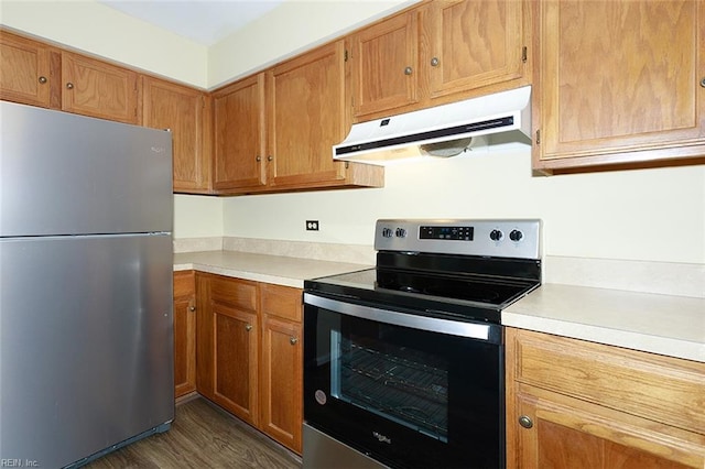 kitchen featuring stainless steel appliances and dark hardwood / wood-style floors