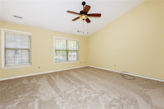 spare room featuring vaulted ceiling, ceiling fan, and carpet flooring