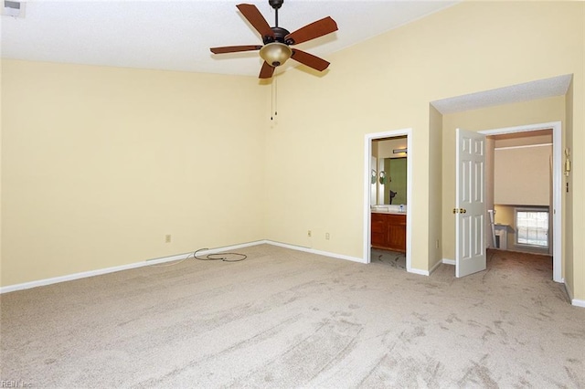 unfurnished bedroom featuring light carpet, connected bathroom, and ceiling fan