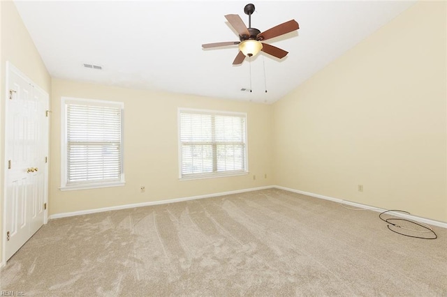 carpeted empty room with lofted ceiling and ceiling fan