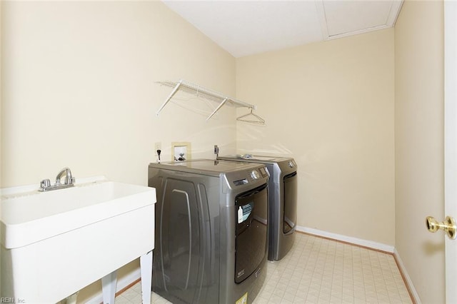 laundry room with independent washer and dryer and sink