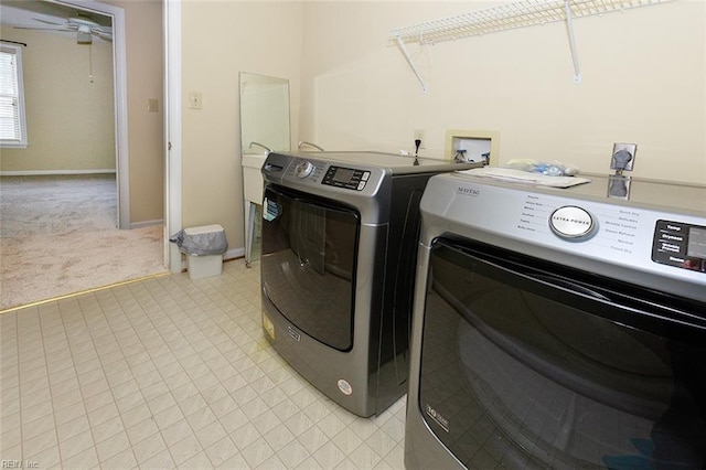 washroom featuring light carpet and washer and clothes dryer